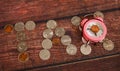 Tax word spelled out with coins and alarm clock.