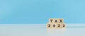 Tax 2022 word on wooden cube blocks blue background. accounting finance economy income. paying taxes concept.