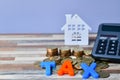 TAX word on wooden home and stack money coins concept Royalty Free Stock Photo