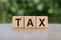 TAX word written on wooden blocks. The concept of taxation, increase taxes and fees Royalty Free Stock Photo