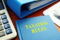 Taxation Rules book with documents and calculator Royalty Free Stock Photo