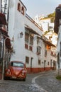 Mini taxi against the Cathedral of Taxco, Mexico.