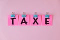 Taxe text on a pink sticker and on pink background Royalty Free Stock Photo
