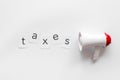 Taxes announcement with megaphone and text on white background top view
