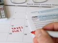 TAXES DUE Reminder Written by Hand on a Calendar in 2022