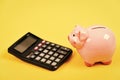 Taxes and fees concept. Tax savings. Piggy bank money savings. Investing gain profit. Piggy bank pig and calculator Royalty Free Stock Photo