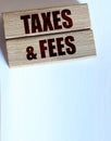 Taxes and fees Text on the wooden blocks, wallet and coins. Business concept Royalty Free Stock Photo