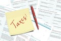 Taxes note, pen and uk tax forms lying on desk Royalty Free Stock Photo