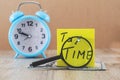 `taxes time` on a sticker with dollars and alarm clock on a wooden table. Tax concept. Royalty Free Stock Photo