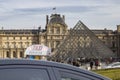 Taxi against the Louvre Palace