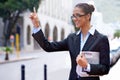 Taxi. an attractive businesswoman with a newspaper hailing a cab in the city. Royalty Free Stock Photo