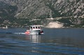 Taxi boat takes people for tours on the island of Our Lady of the Rocks, Perast, Montenegro