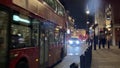 Taxi, Bus, London UK - Feb 13th 2019: black taxi cab bus red phone box on the Strand road night London England . Tourism landmar