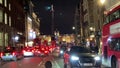 Taxi, Bus, London UK - Feb 13th 2019: black taxi cab bus red phone box on the Strand road night London England . Tourism landmar