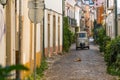 Taxi cab drive tourists through a central streets in Tomar, Ri