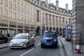 A taxi cab and a London bus at the entrance to Regent Street Royalty Free Stock Photo