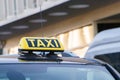 Taxi car on the street at day time,taxi sign on the cab roof while parking on the road waiting for passaenger vintage film photo Royalty Free Stock Photo