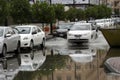 A taxi carefully through the built-up rain water in the streets of Riyadh, Saudi Arabia