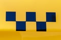 Taxi checkers on the yellow car body. A classic symbol of public transport around the world Royalty Free Stock Photo