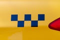 Taxi checkers on the yellow car body. A classic symbol of public transport around the world Royalty Free Stock Photo