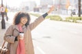 Taxi, coffee and commuting with a business black woman calling or hailing a cab outdoor in the city. Street, travel and Royalty Free Stock Photo