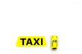 Taxi concept. Yellow service sign text taxi near car toy on white background top view copy space