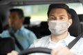 Taxi driver in face protective mask driving car Royalty Free Stock Photo