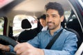 Taxi driver with passenger at back seat. Royalty Free Stock Photo