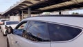 Taxi driver resting car airport parking, legs outside, passenger transportation Royalty Free Stock Photo