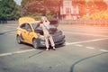 Taxi driver saves the car from overheating on a hot summer day. Problems with engine in car standing, middle of the road. Driver