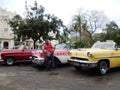 TAXI DRIVER AND VINTAGE AMERICAN CARS, HAVANA, CUBA Royalty Free Stock Photo