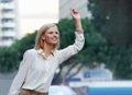 Taxi. A gorgeous woman hailing a cab after a long day of clothes shopping.