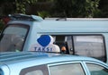 Taxi light sign or cab sign in blue and white color on the blue color of car roof at the street