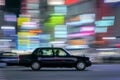 Taxi with light trails motion blur background at the Shibuya Crossing