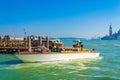 Taxi motoboat with masquerade passengers speeding in Venice lagoon Italy Royalty Free Stock Photo