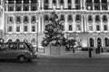 A taxi passing by a Christmas tree in Central London