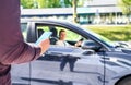 Taxi phone app for cab or car ride share service. Customer waiting driver to pick up on city street. Man holding smartphone. Royalty Free Stock Photo