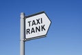 Taxi rank sign blue sky background black cab uber transport post queue wait signage London Royalty Free Stock Photo