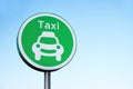 Taxi rank sign and vehicle car symbol against plain blue sky for private transport Royalty Free Stock Photo