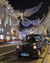 Taxi with Regent Street Christmas Lights in London, UK Royalty Free Stock Photo