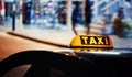 Taxi sign on the roof of a car