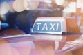 Taxi sign on top of the car with copy space with bokeh light Royalty Free Stock Photo