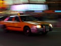 Taxi speeds down the street Royalty Free Stock Photo