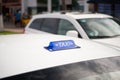 Taxi top sign on white cab roof Royalty Free Stock Photo