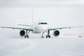 Taxiing passenger airplane in a snow blizzard