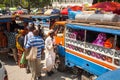 Taxis full of passengers at local market.