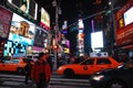 Taxis and pedestrians crowd Times Square at night Royalty Free Stock Photo