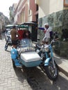 TAXIS AND TAXI DRIVERS IN A STREET IN HAVANA, CUBA