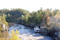 Taylors Falls Minnesota Paddleboat on the St. Croix River in the fall with fog lifting from the cliffs Royalty Free Stock Photo