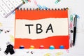 TBA (abbreviation of to be announced) word is written on a sheet Royalty Free Stock Photo